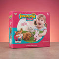 Product box for Little Joy 'Plush Pet Mini Pethouse' showing a girl playing with a tan plush dog, white plush puppy and pink plush bunny, labeled 3+ Ages and Electronic Walk Wow Function